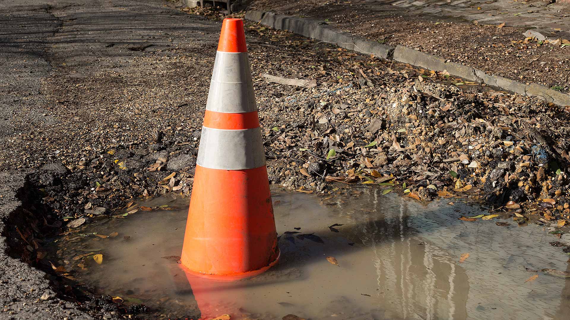 Traffic cone in a pothole