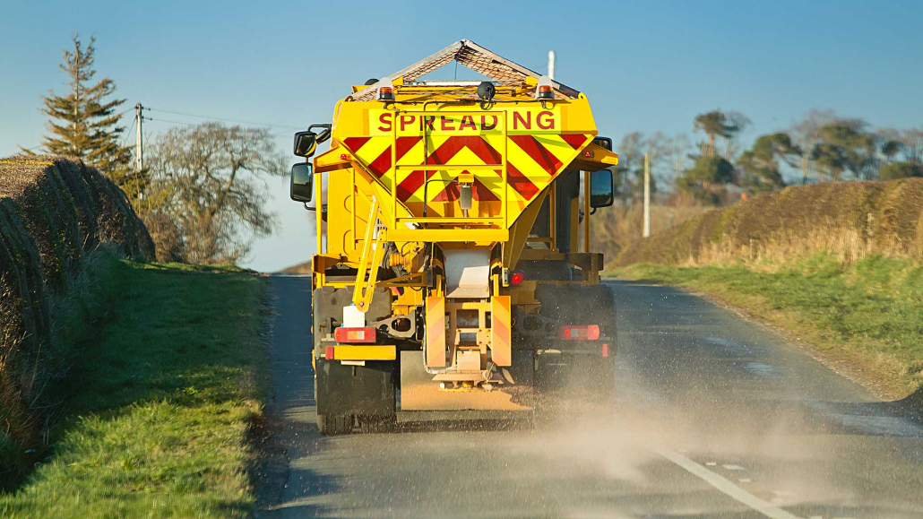 Road gritter spreading salt in winter