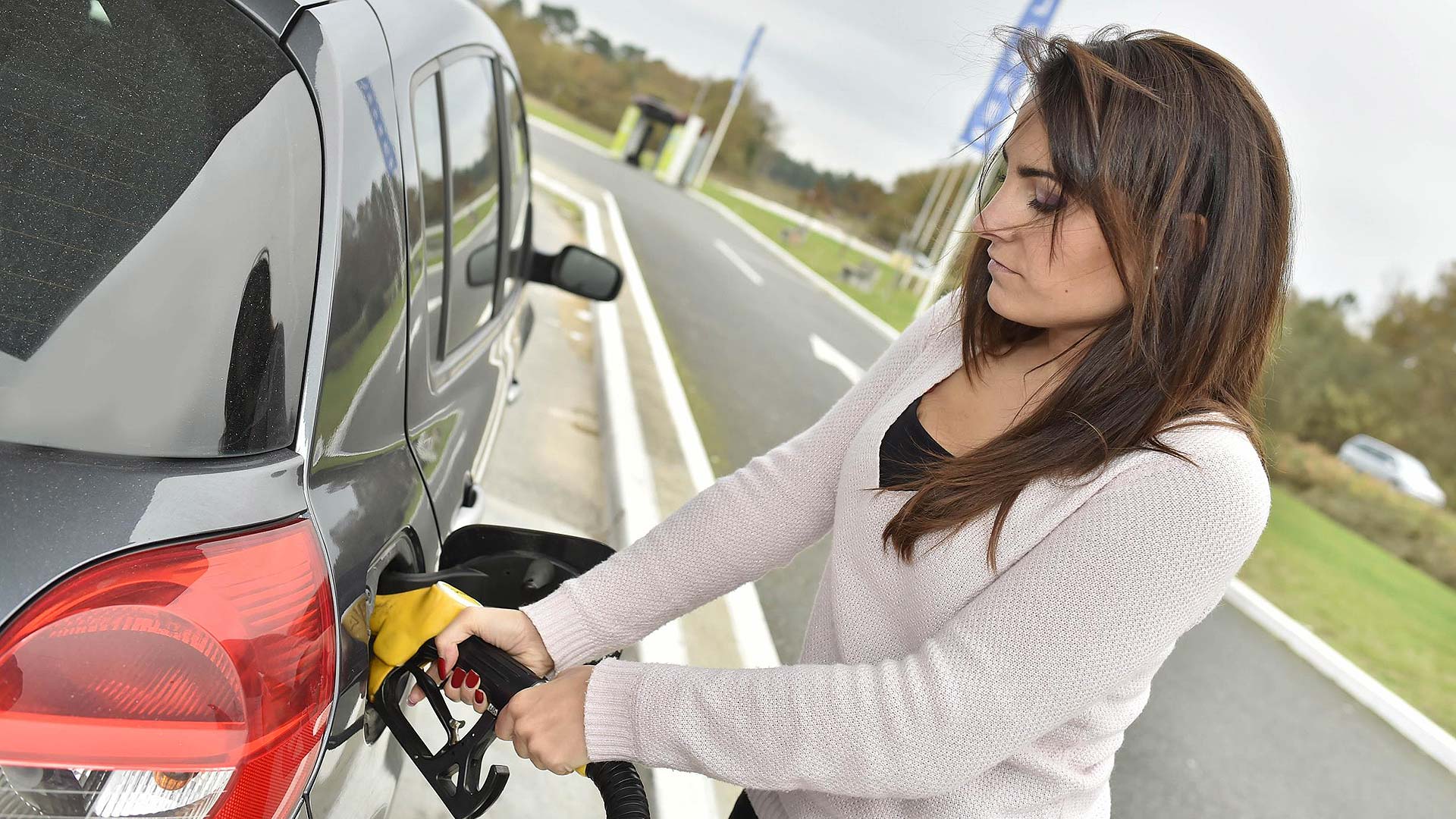 Woman filling up car