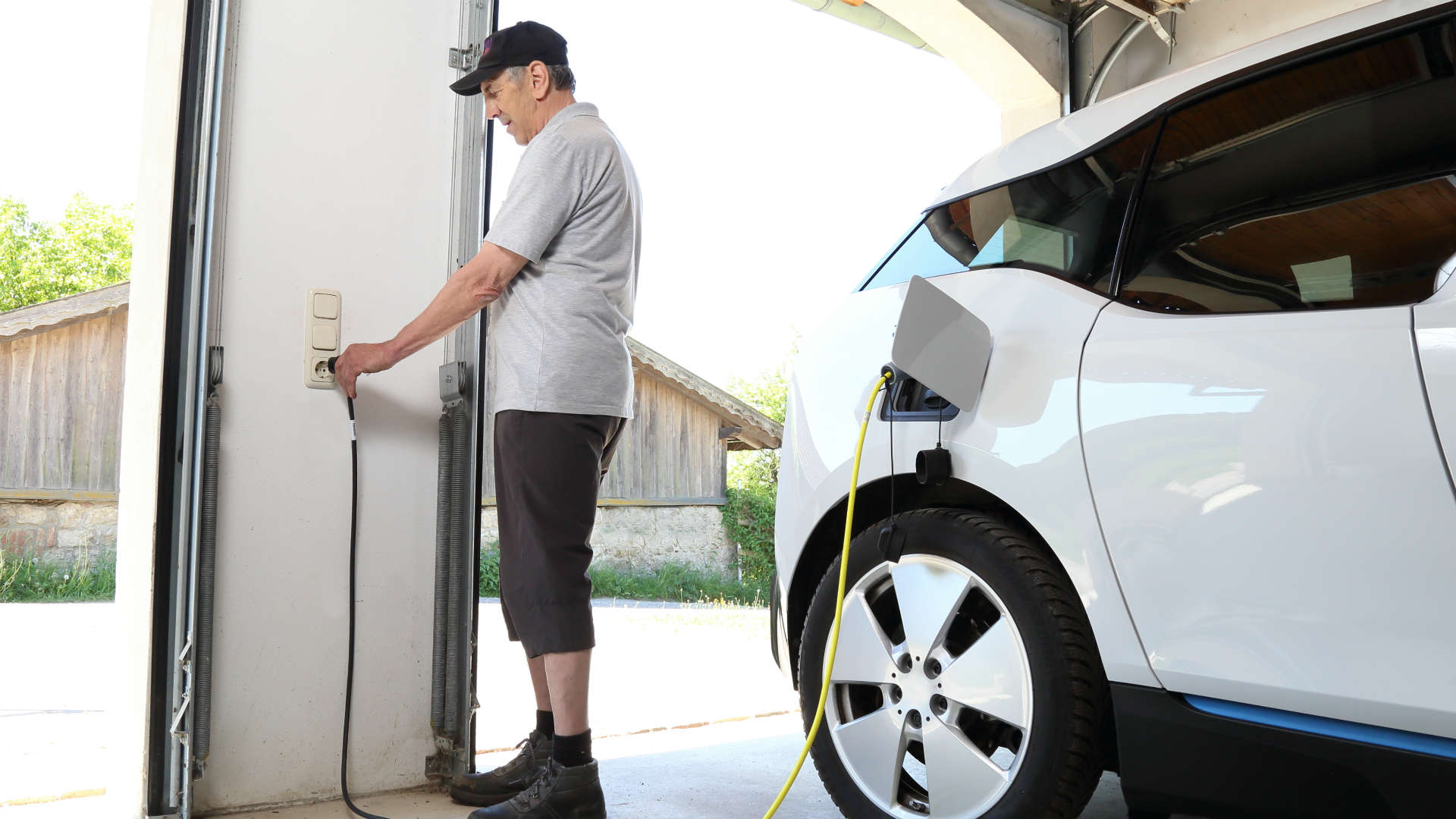 Man charging BMW i3 at home