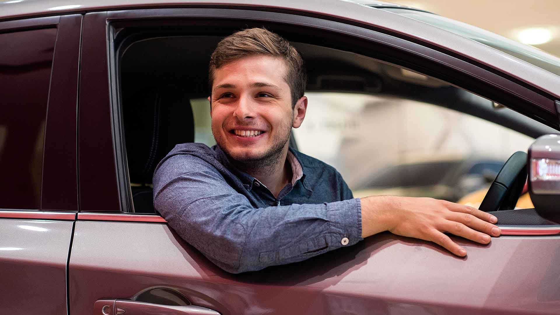 Young motorist sitting in the driving seat